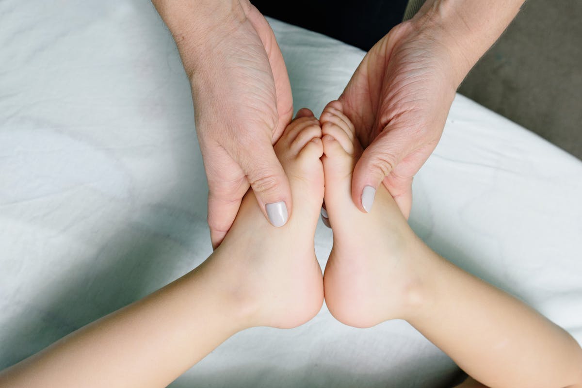 Person Massaging Baby Feet