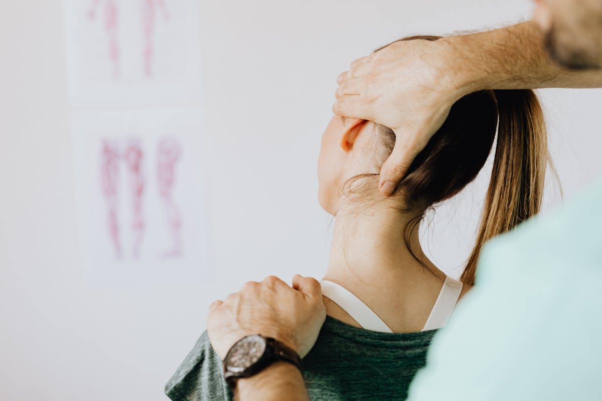 Professional Massage Therapist Treating a Female Patient's Injured Neck